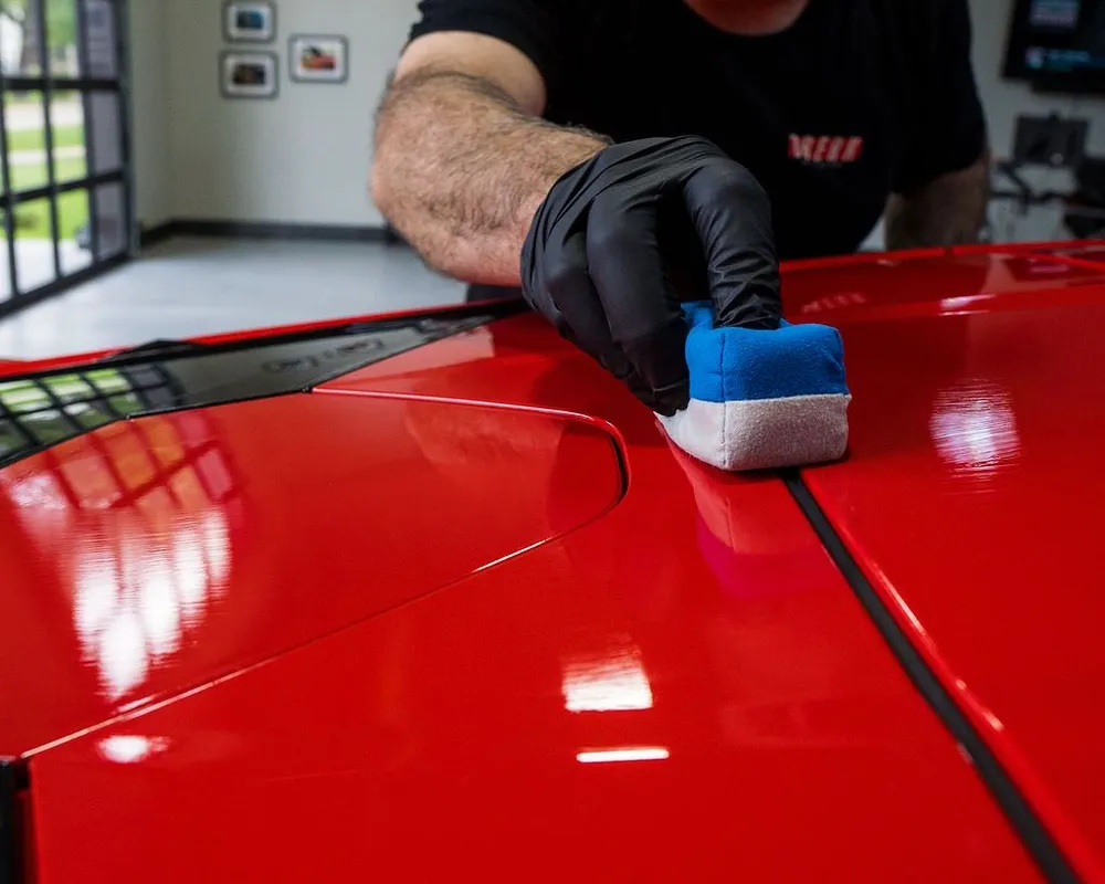 Ceramic coating application on a red car at Tint Pros Platinum Auto Wraps in Vancouver, WA—protective paint finish work.